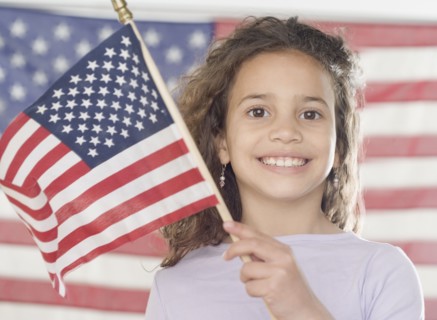 Young girl holding American flag