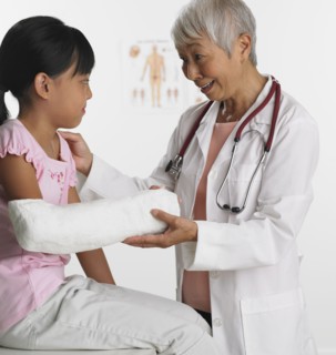 Senior Asian female doctor with young patient