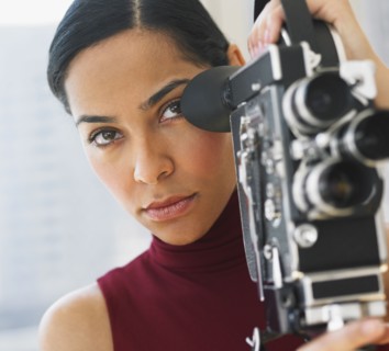 African woman using old fashioned film camera