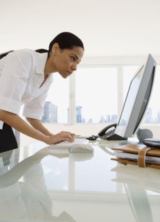 African businesswoman looking at computer