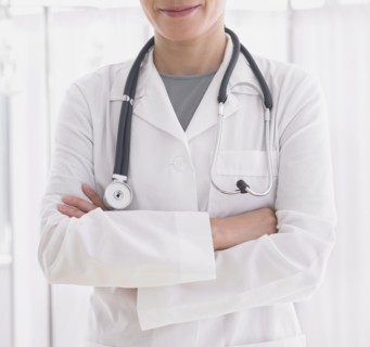 Close up of female doctor with arms crossed