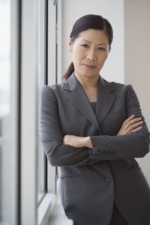 Middle-aged Asian businesswoman with arms crossed