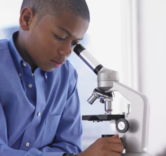 African boy looking into microscope