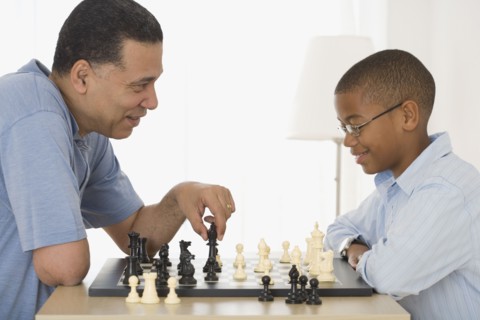 African father and son playing chess