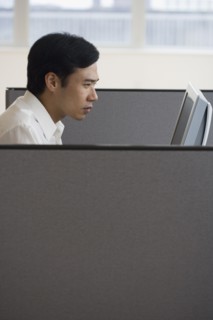 Asian businessman working in cubicle