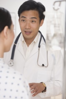 Asian male doctor talking to patient