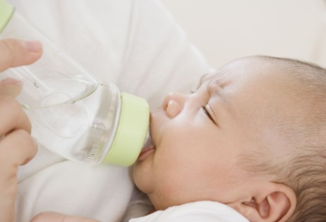 Close up of newborn baby drinking from bottle