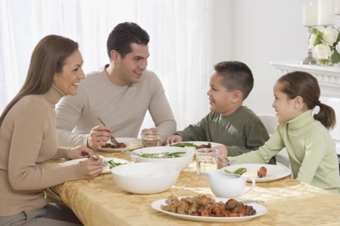 Hispanic family eating at dinner table