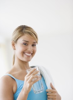 Hispanic woman drinking glass of water
