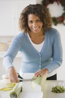 African woman wrapping gift