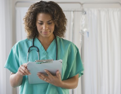 African female doctor looking at chart