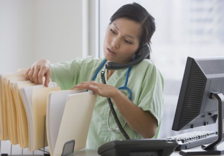 Asian female doctor talking on telephone