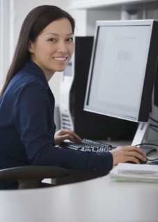 Asian businesswoman sitting at computer