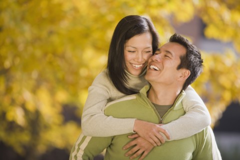 Asian woman hugging boyfriend