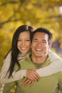 Asian woman hugging boyfriend