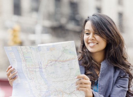 Mixed Race woman looking at map
