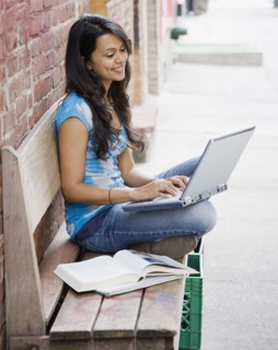 Mixed Race woman typing on laptop