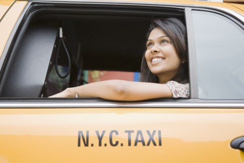 Mixed Race woman looking out taxi cab window