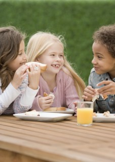 Multi-ethnic girls eating sandwiches