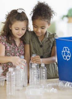 Multi-ethnic girl recycling bottles