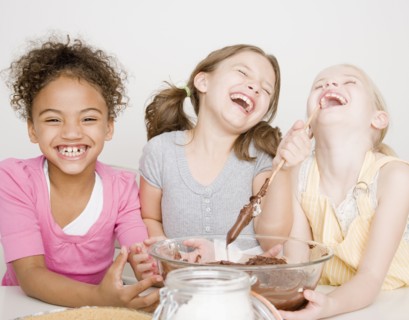 Multi-ethnic girls making batter