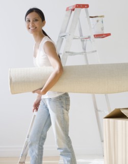 Pacific Islander woman carrying rug