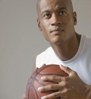 African man holding basketball