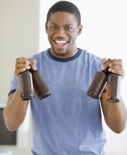 African man holding bottles of beer
