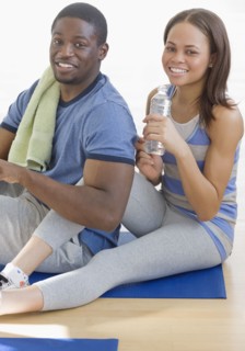African couple sitting on yoga mat