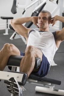 Hispanic man exercising in gym