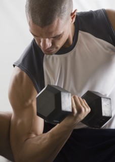 Hispanic man lifting free weights