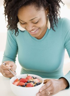 African woman eating cereal