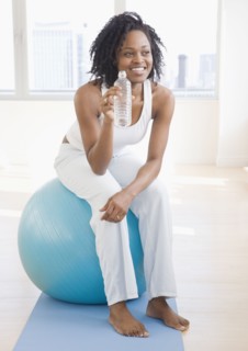 African woman sitting on exercise ball
