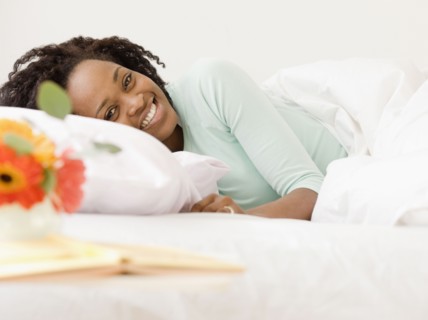African woman laying in bed
