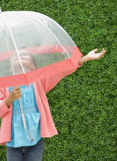 Mixed race girl with umbrella in the rain