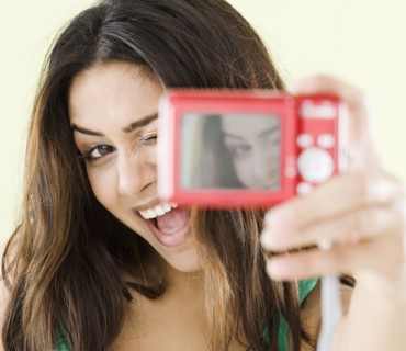 Middle Eastern woman taking self-portrait