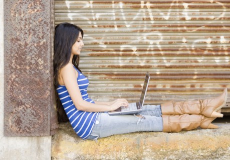 Middle Eastern woman typing on laptop