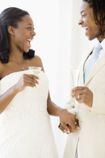 African bride and groom holding champagne flutes
