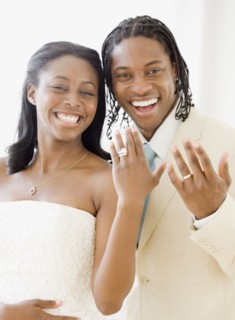African bride and groom showing wedding rings