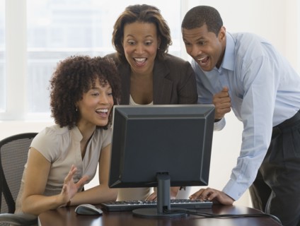 African people looking excited working on computer