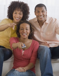African man and women watching television