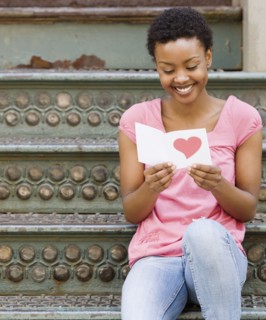 African woman reading Valentine's Day card