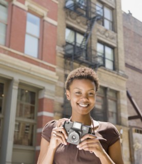 African woman holding camera