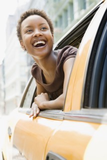African woman looking out taxi window in wonder