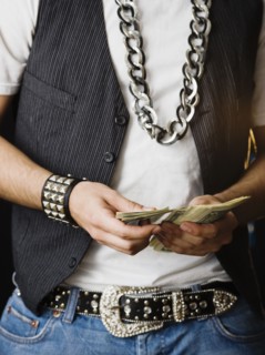 Hispanic man counting stack of money