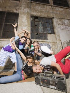 Alternative friends break dancing in urban setting