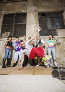 Alternative friends break dancing in urban setting