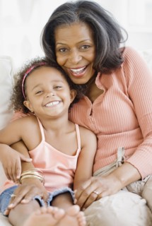 African grandmother hugging granddaughter
