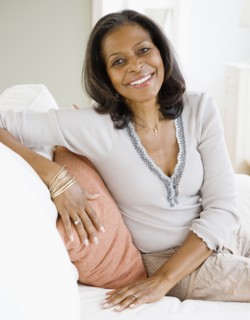 Confident African woman smiling in living room