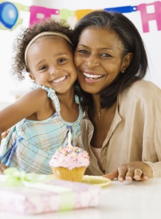 African grandmother hugging granddaughter on her birthday